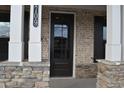 Elegant front door with glass panels and stone accents creating a warm and inviting entry at 3709 Tielman St, Snellville, GA 30078