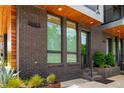 Close-up of unit exterior with brick facade, wood accents, and modern windows, set amidst lush landscaping at 105 Georgia Se Ave # 5, Atlanta, GA 30312