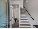 Bright staircase with white risers, wood treads, and sleek black railing, leading to the upper level at 105 Georgia Se Ave # 5, Atlanta, GA 30312