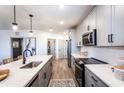Modern kitchen with gray cabinets and stainless steel appliances at 3351 Orwell Way # 2206, Cumming, GA 30041