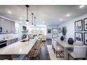 Open concept kitchen, dining, and living area with hardwood floors at 3351 Orwell Way # 2206, Cumming, GA 30041