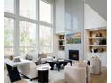 Bright living room boasting soaring windows, a fireplace, and built-in shelving at 7170 Pond View Dr, Cumming, GA 30028