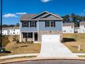 Two-story house, blue siding, stone accents, two-car garage, and a landscaped yard at 37 Willow Green Trce, Dallas, GA 30157