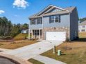 Two-story house with blue siding, stone accents, and a two-car garage at 37 Willow Green Trce, Dallas, GA 30157
