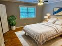 Bright bedroom with a white bed, gray walls, and hardwood floors at 1683 Briarcliff Ne Rd # 4, Atlanta, GA 30306