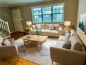 Living room with beige sofas, wooden coffee table, and hardwood floors at 1683 Briarcliff Ne Rd # 4, Atlanta, GA 30306