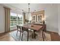 Bright dining room with hardwood floors, large windows, and a wood table at 5505 Julep Ct, Cumming, GA 30028