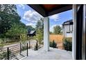 Covered porch with white columns and a view of a residential street at 192 East Lake Se Ter, Atlanta, GA 30317