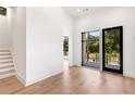 Bright hallway with light hardwood floors and access to a patio at 192 East Lake Se Ter, Atlanta, GA 30317