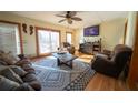 Bright living room with hardwood floors, comfy furniture, and large windows at 633 Duncan Rd, Oxford, GA 30054