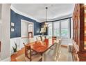 Elegant dining room boasts a large table, hardwood floors, and a stunning chandelier at 1037 Emory Parc Pl, Decatur, GA 30033
