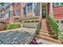 Townhome exterior, featuring brick facade, attached garage, and manicured landscaping at 1037 Emory Parc Pl, Decatur, GA 30033