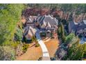Luxury home nestled on a wooded lot with circular driveway at 922 Little Darby Ln, Suwanee, GA 30024