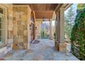 Covered stone porch with flagstone flooring at 922 Little Darby Ln, Suwanee, GA 30024