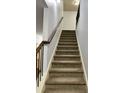 Staircase with carpeted steps and a wooden handrail at 2249 Knoxhill Se Vw, Smyrna, GA 30082
