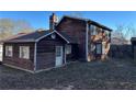 Back of house with additional building and fenced yard at 3709 Charlotte Dr, Rex, GA 30273