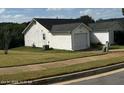 Rear view of house showcasing garage and yard at 416 Autumn Lake Ct, Mcdonough, GA 30253