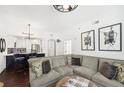 Spacious living room featuring a gray sectional sofa, art, and hardwood floors at 2277 Peachtree Ne Rd # 405, Atlanta, GA 30309