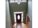 Welcoming foyer with a transom window, sidelights, and chandelier creating a bright, inviting space at 2710 Factor Walk Blvd, Suwanee, GA 30024