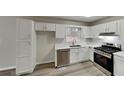Modern kitchen with white cabinets, stainless steel appliances, and quartz countertops at 368 Sumer Ln, Douglasville, GA 30134