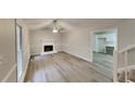 Light and airy living room with fireplace, hardwood floors, and kitchen view at 368 Sumer Ln, Douglasville, GA 30134