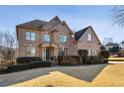 Brick two-story house with landscaping and driveway at 602 Davenport Pl, Canton, GA 30115