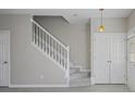 Front entry staircase with white railing and gray carpeting at 1761 Stanwood Nw Dr, Kennesaw, GA 30152