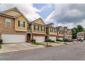 Exterior shot of attached townhomes with attached garages and landscaping at 53 Providence Oak Ct, Lawrenceville, GA 30046