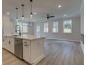 Open concept kitchen boasts white cabinets, island, and stainless steel appliances at 163 Bluffington Way, Marietta, GA 30066