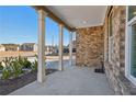 Charming front porch with classic columns, brick accents, and a view of the neighborhood at 1920 Pearson St, Loganville, GA 30052