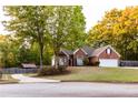 Brick home with attached garage and landscaped lawn at 2063 Emily Dr, Social Circle, GA 30025