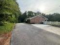 Asphalt driveway leading to brick home at 1294 Dogwood Rd, Snellville, GA 30078