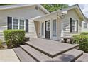 Inviting front porch with gray wooden steps and black door at 2192 Spink St, Atlanta, GA 30318