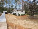 A nice view of the home featuring a long driveway, well-maintained yard, and a detached storage shed at 2771 Ridge Park Dr, Tucker, GA 30084