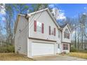 Two-story house with attached garage and red shutters at 6207 Willowbrook Dr, Riverdale, GA 30296