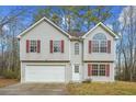 Two-story house with attached garage and red shutters at 6207 Willowbrook Dr, Riverdale, GA 30296