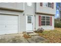 White door and attached garage with gray siding at 6207 Willowbrook Dr, Riverdale, GA 30296