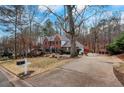 Landscaped yard with driveway, mailbox, and trees at 2530 Ashbourne Dr, Lawrenceville, GA 30043