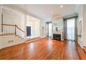 Bright living room featuring hardwood floors and a stately staircase at 1005 Lenox Valley Ne Dr, Atlanta, GA 30324