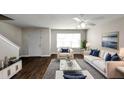Spacious living room with hardwood floors, comfy seating, and large windows at 4229 Reeshemah St, Union City, GA 30349