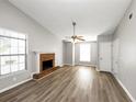 Living room with brick fireplace and wood-look flooring at 5277 Brentwood Rd, Atlanta, GA 30349