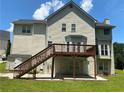 Two-story house with a wooden deck and stairs, and well-maintained yard at 1886 Clay Sw Dr, Marietta, GA 30064