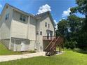 Two-story house with a wooden deck and stairs, and well-maintained yard at 1886 Clay Sw Dr, Marietta, GA 30064