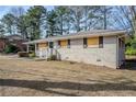 Side view of brick ranch house needing some repairs at 1967 Glen Echo Dr, Decatur, GA 30032