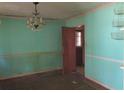 Dining room with light teal walls and chandelier at 1971 Honeysuckle Sw Ln, Atlanta, GA 30311