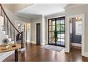 Spacious entry with hardwood floors, a staircase, and a view of the office at 571 Glen Eagles Se Cir, Marietta, GA 30067