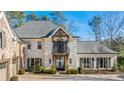 Elegant home with a white brick facade and black shutters at 571 Glen Eagles Se Cir, Marietta, GA 30067
