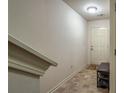 Inviting entryway with tile flooring, shoe rack, and a neutral-colored front door providing a warm welcome at 177 Oakland Hills Way, Lawrenceville, GA 30044