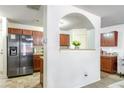 Modern kitchen with stainless steel appliances, tile flooring, and ample counter space at 177 Oakland Hills Way, Lawrenceville, GA 30044