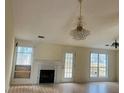 Bright living room featuring a fireplace and elegant chandelier at 2800 Camelot Woods Dr, Lawrenceville, GA 30044